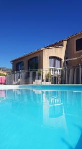 a large swimming pool in front of a house at La Châteaude in Aubagne