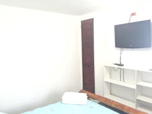 a living room with a tv on a wall at Maracaibo View in Providencia