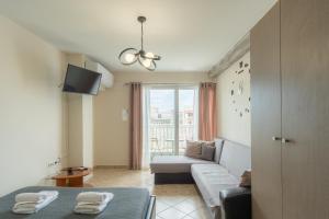 a living room with a couch and a window at Downtown Hub 1 in Alexandroupoli +19 photos