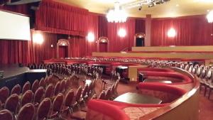 an empty auditorium with red chairs and a stage at Plaza Hotel & Casino in Las Vegas