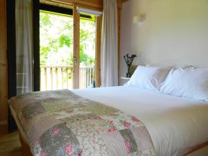 a bedroom with a large bed with a window at Treehouse Quinta Lamosa in Arcos de Valdevez