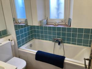 a bathroom with a bath tub with a blue towel at Casa Olivella in Olivella
