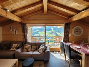 a living room with a couch and a table at Chalet Les Gets, 5 pièces, 6 personnes - FR-1-598-24 in Les Gets