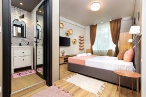 a bedroom with a bed and a mirror at Kapana Guest House on Central Pedestrian street with Parking included in Plovdiv