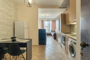 a kitchen and living room with a table at Sunshine Apartments 1 in Alexandroupoli