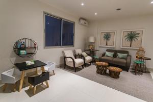 a living room with a couch and a table at JR Hotel Marilia in Marília