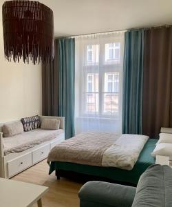 Łóżko lub łóżka w pokoju w obiekcie Apartamenty i Studia HERBARIUM