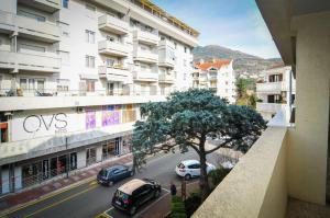 a city street with cars parked in front of buildings at Apartmani Andjelka in Tivat