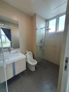 a bathroom with a toilet and a sink and a shower at Southbay Seaview Condo A10 #10minQueensbay #15minSPICE in Bayan Lepas