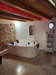 a bath tub in a room with a stone wall at La casetta nel vicolo in Palermo +5 photos