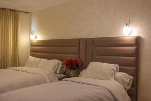 Postel nebo postele na pokoji v ubytování Hôtel Des Lilas