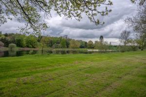 a park with a river and a grass field at Kirsty's Home Near Alton Towers in Rocester