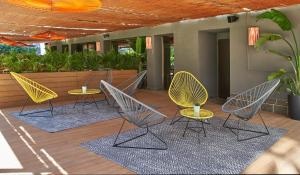 a group of chairs and tables on a patio at The Moods Oasis in Barcelona