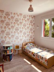 a bedroom with a bed and a wall with hearts at Maison piscine Bassin Arcachon in La Teste-de-Buch +3 photos