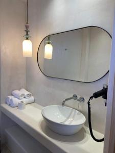 a bathroom with a white sink and a mirror at Pefkos Blue in Pefki Rhodes