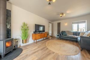 a living room with a fireplace and a couch at Castle Bungalow in Thornham