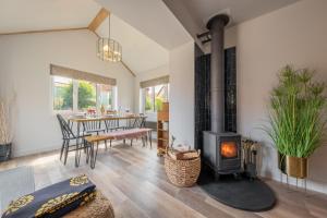 a living room with a fireplace and a dining room at Castle Bungalow in Thornham