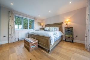 a bedroom with a large bed and a window at Anchorage S in Salthouse