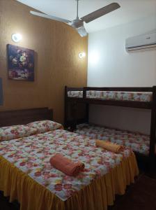 a bedroom with a bed with two bunk beds at Apartamentos Victoria in Asuncion