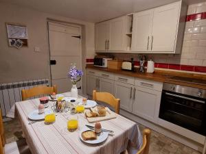 a kitchen with a table with food on it at Lightfoot House in Redmire