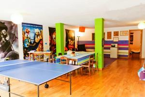 a room with a ping pong table in it at Coloured Studio in Faro