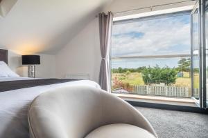 Holme next the SeaにあるWynholmeのベッドと大きな窓のある寝室