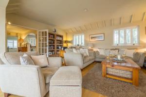 a living room with couches and a coffee table at Whitehaven in Brancaster