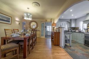 a kitchen and dining room with a table and chairs at Whitehaven in Brancaster