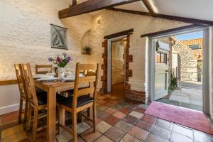 a dining room with a wooden table and chairs at The Old Chapel W in Little Walsingham