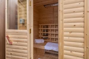 a sauna with wooden walls and a wooden floor at The Old Chapel in Pentney