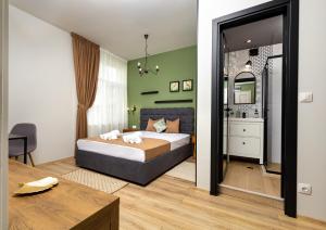 a bedroom with a bed and a table in a room at Kapana Guest House on Central Pedestrian street with Parking included in Plovdiv