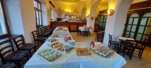 a dining room with two tables with food on them at Peregrin Sveta Gora in Solkan