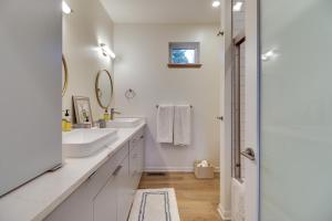 a white bathroom with two sinks and a mirror at Columbia Falls Home with Patio Near Glacier NP! in Columbia Falls +29 photos