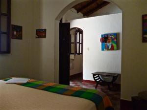 a bedroom with a bed and a table in a room at Casa Silas Granada Nicaragua in Granada +7 photos