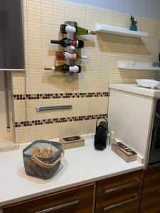 a kitchen counter with a bottle of wine on a wall at Lovely Home in Avezzano