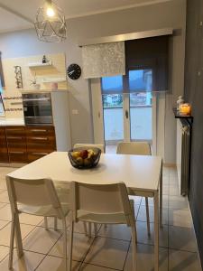 a kitchen with a table with a bowl of fruit on it at Lovely Home in Avezzano