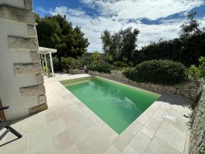 a swimming pool in the backyard of a house at Villa del 1700 immersa nel verde, Poggio al Sole Vieste in Vieste