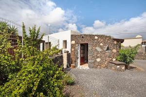 a house with a stone wall and a door at Yukalele 2 in Lajares