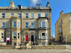 an old brick building with a red door at One Moorgate View in York