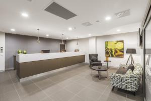 a waiting room with chairs and a reception desk at Quest Liverpool in Liverpool