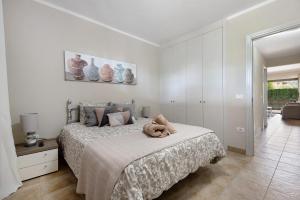 a bedroom with a bed with a teddy bear on it at Casa Fran in Puerto de la Cruz +20 photos