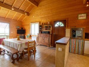 a kitchen and dining room with a table in a cabin at Charmante maison avec piscine privée, climatisation, WiFi et parking - FR-1-616-166 in Montagnac-dʼAuberoche