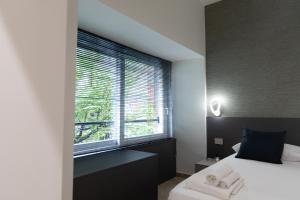 a bedroom with a bed and a large window at CIVICO 237 in Naples