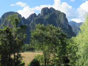 a mountain range with trees in the foreground at Maylyn Guesthouse in Vang Vieng