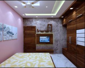 a bedroom with a bed and a tv on a wall at Flagship Hotel Sweta Villa in Patna