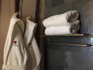 a group of towels on a rack in a bathroom at Remota Patagonia Lodge in Puerto Natales
