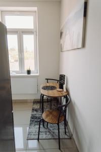 a room with a table and two chairs and a window at Studio Centrum in Chełm