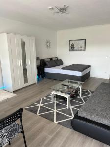 a living room with a bed and a coffee table at Idyllisches Apartment - Moderne 1ZKB Balkon 2 Personen Self-Check-in 24h in Bad Nauheim