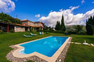 a swimming pool in the yard of a house at Leiras de Candoz Douro Valley in Marco de Canaveses