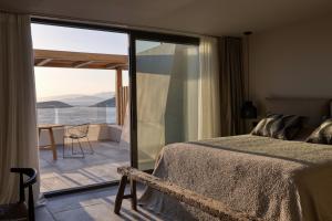 una camera con letto e vista sull'oceano di Minos Palace Hotel & Suites - Adults Only ad Ágios Nikólaos
